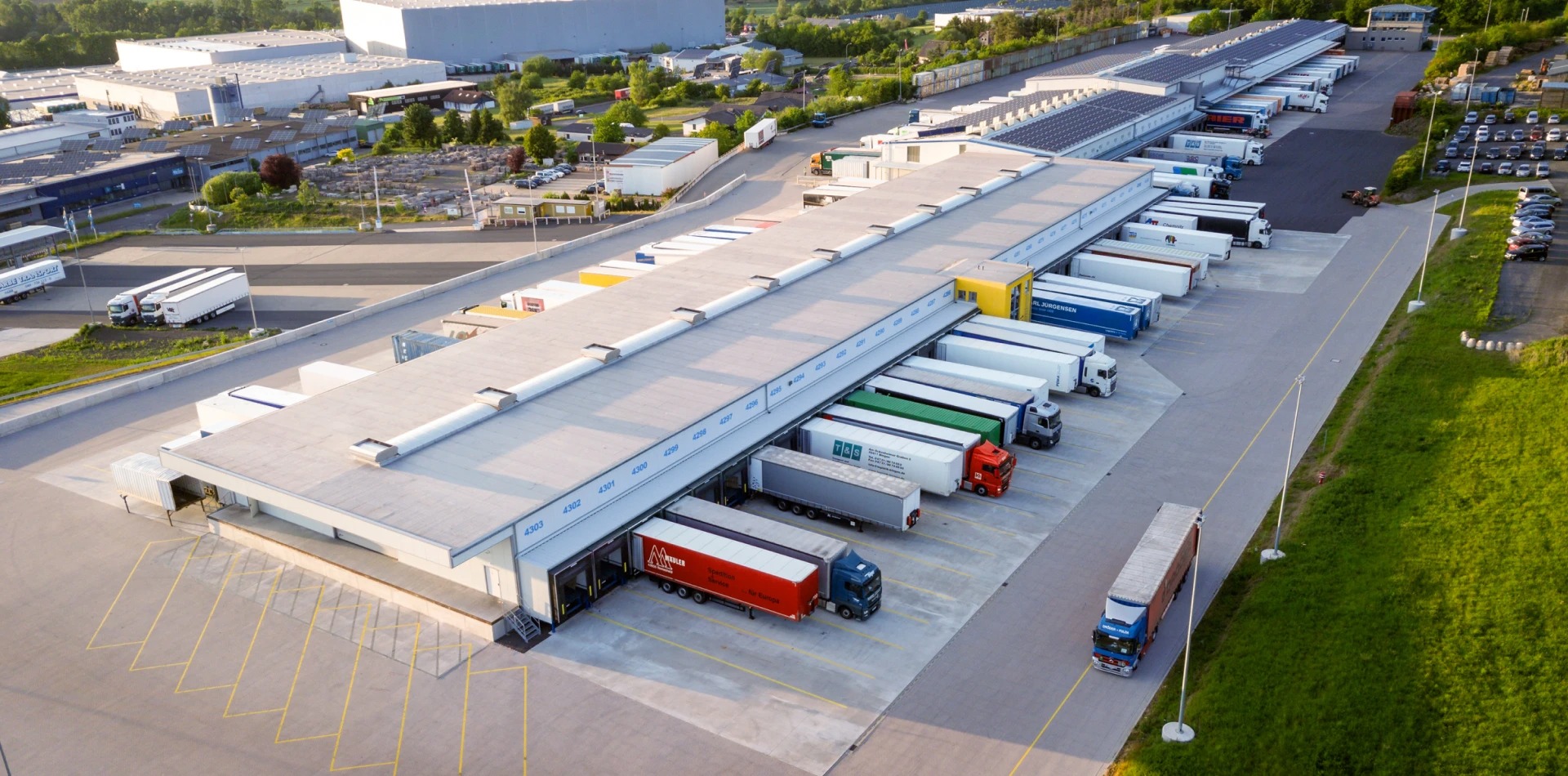 Aerial view of an AirSwift Logistics cross-dock terminal with freight trucks at the loading docks